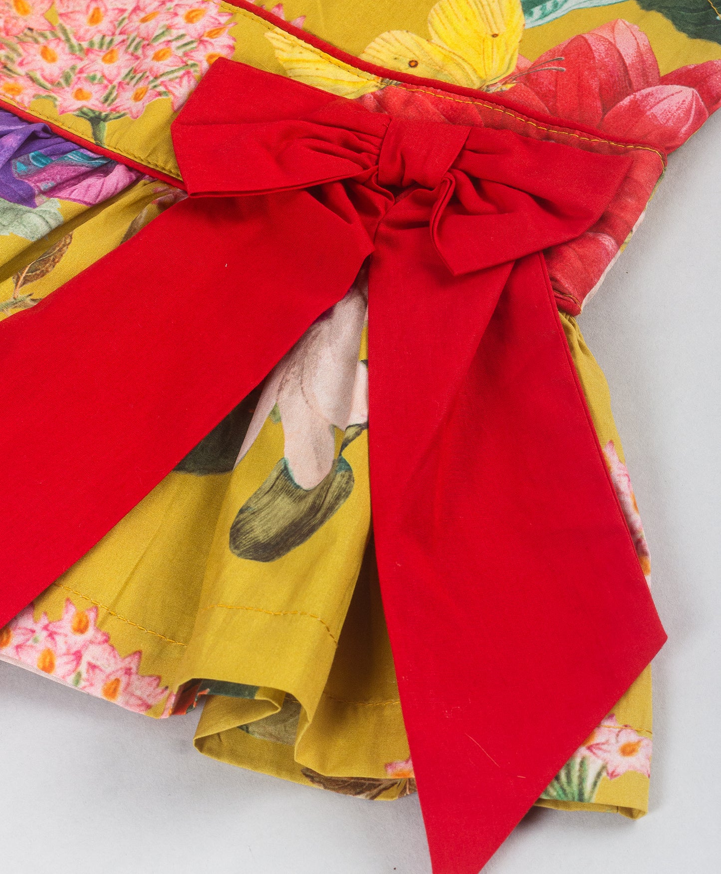 YELLOW FLORAL PRINT TOP WITH RED BOW AT WAIST