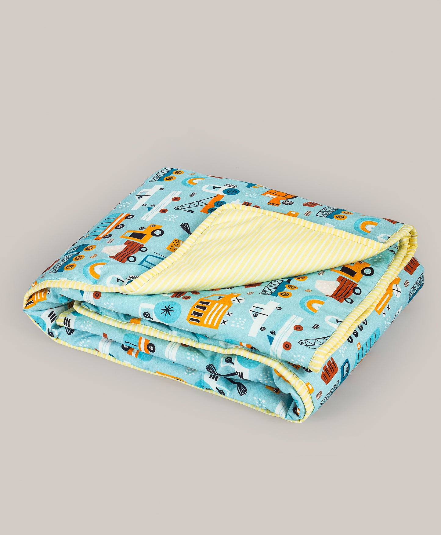 VEHICLE PRINT AC QUILT WITH STRIPE PRINT LINING.