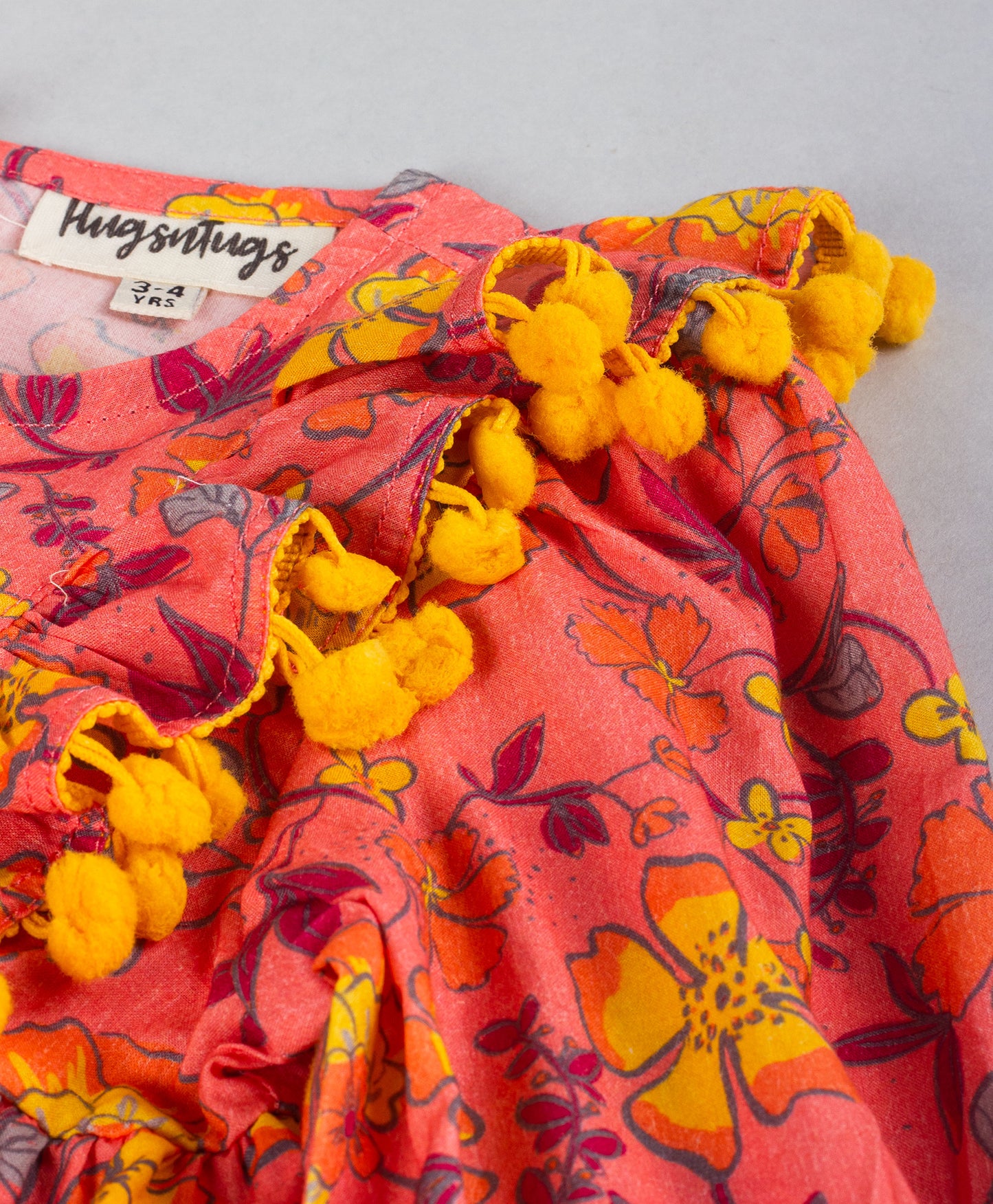 CORAL FLOWEL PRINT TOP WITH YELLOW POMPOM DETAILING