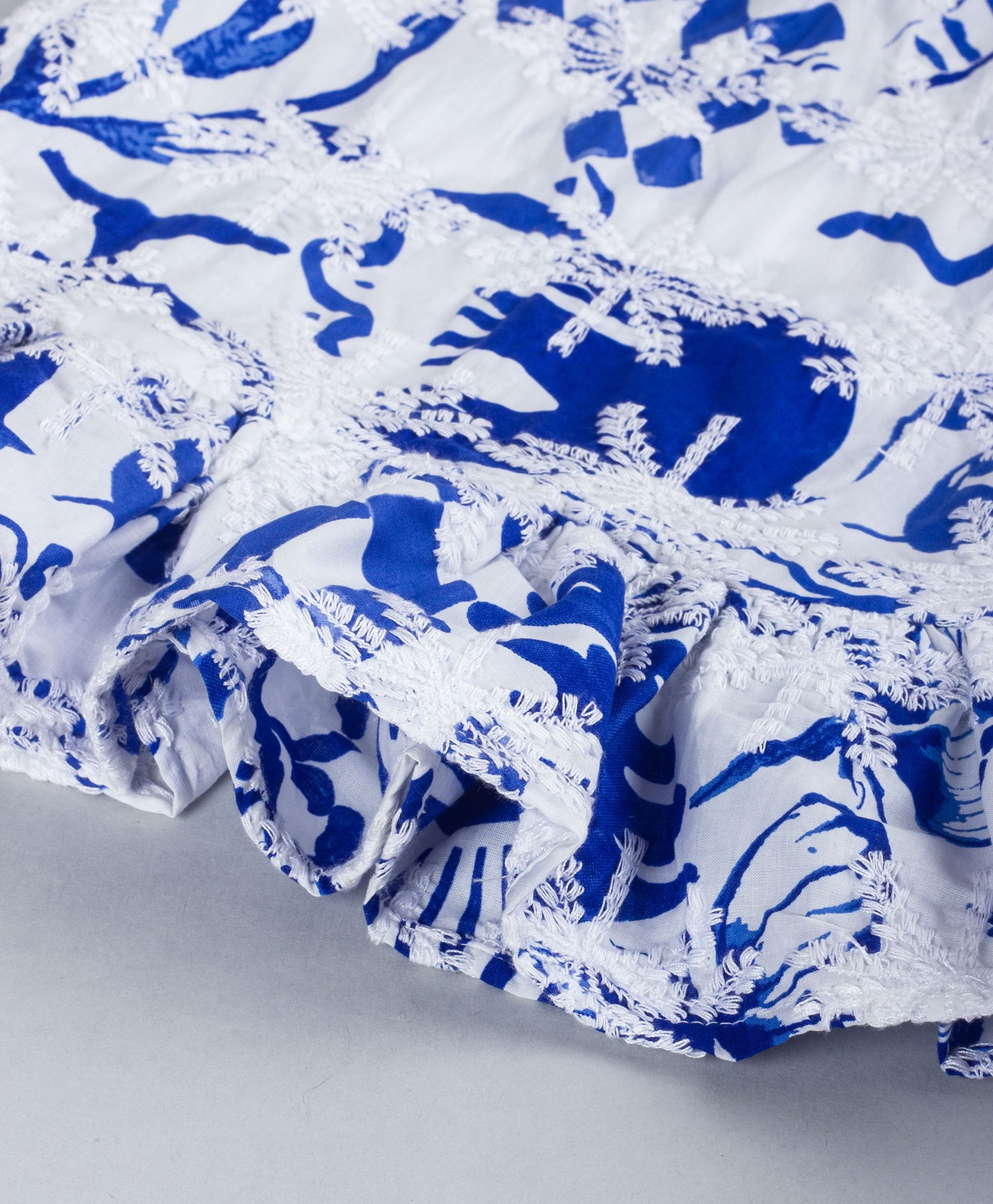 BLUE AND WHITE SCHIFFLI EMBROIDERY PEPLUM TOP