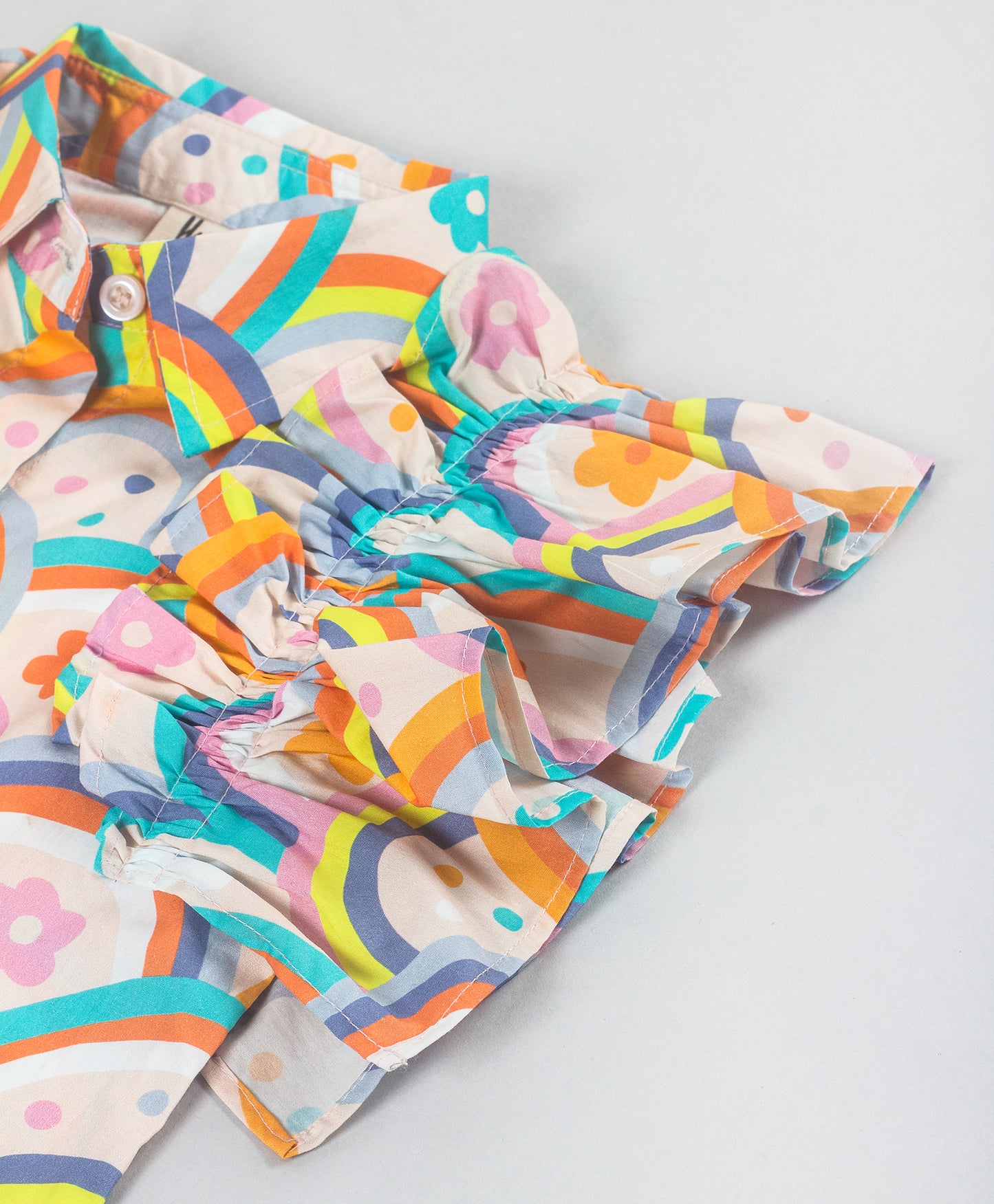 RAINBOW PRINT TOP WITH RUFFLES ALONG THE ARMHOLE