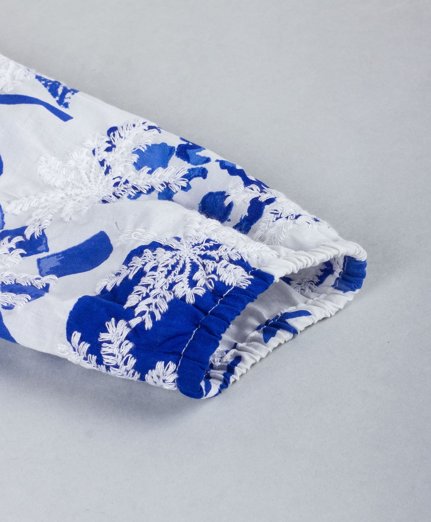 BLUE AND WHITE SCHIFFLI EMBROIDERY PEPLUM TOP