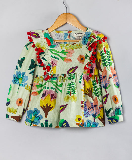 ECRU TOP WITH MULTI FLORAL PRINT AND RED POMPOM DETAILING