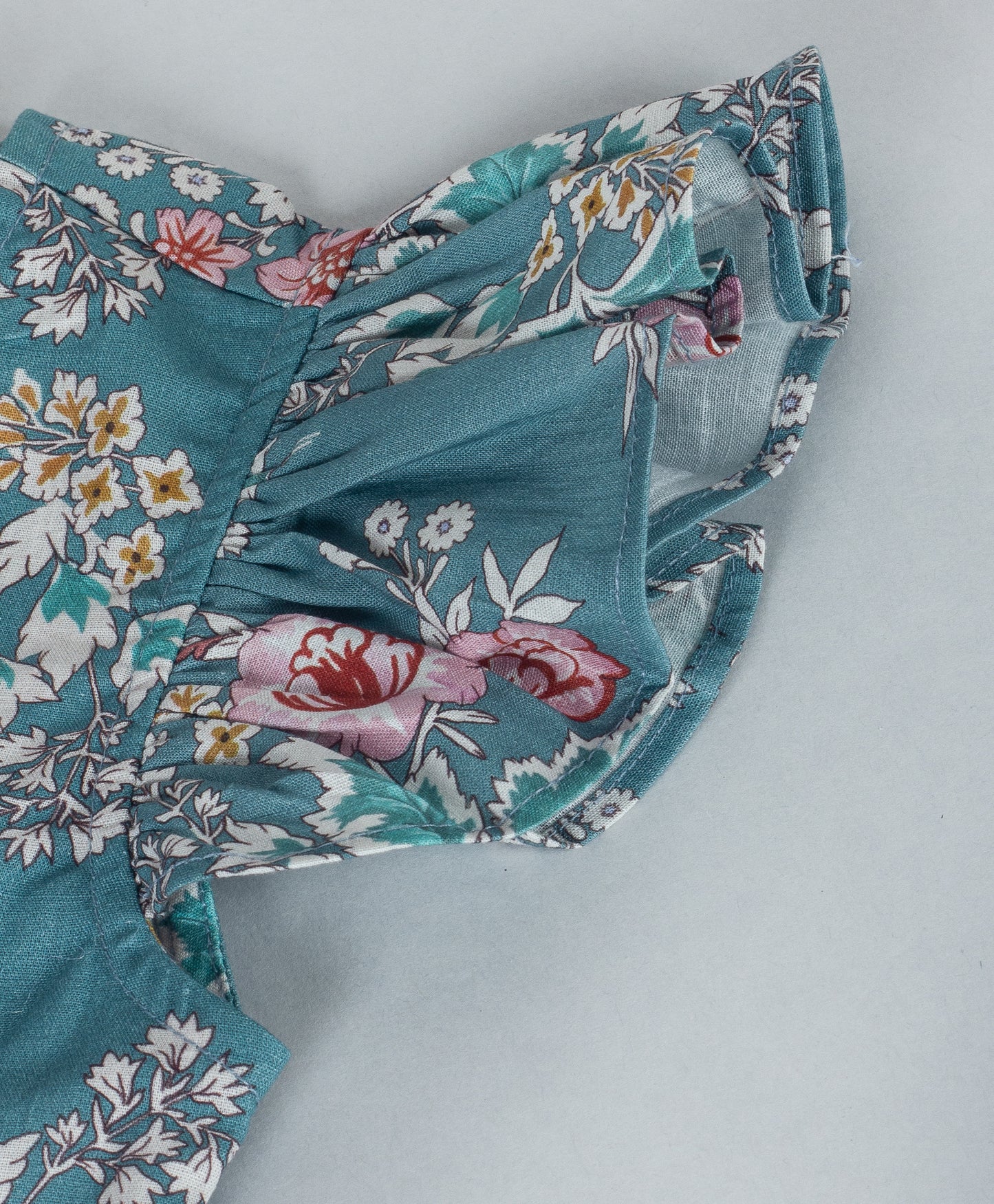 TEAL BLUE FLOWER PRINT DRESS WITH CORAL BOWS ON SIDE WAIST