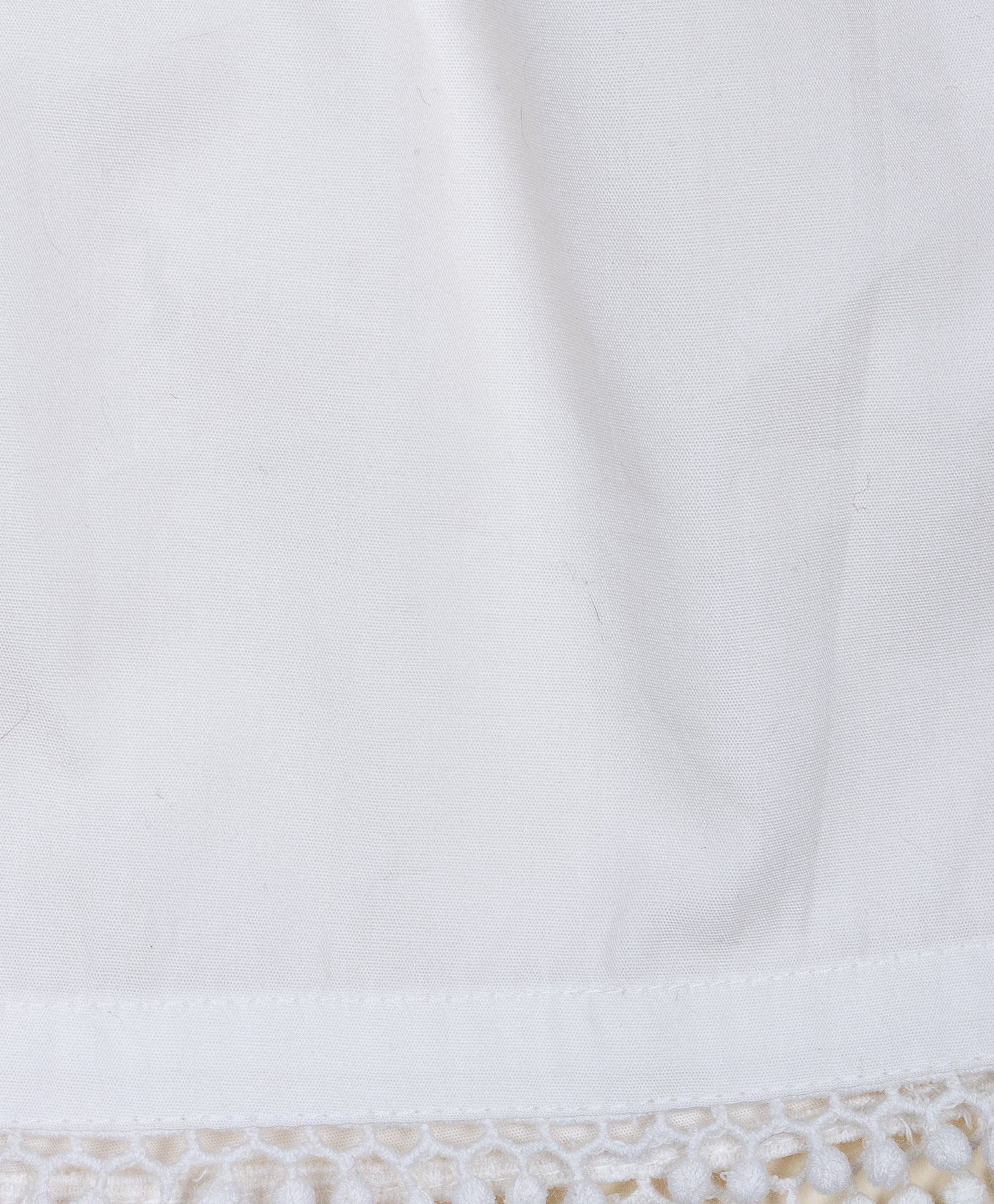 Solid White shorts with pom pom lace detailing at the bottom