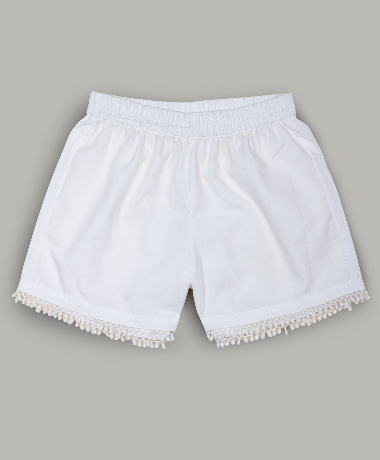 Solid White shorts with pom pom lace detailing at the bottom