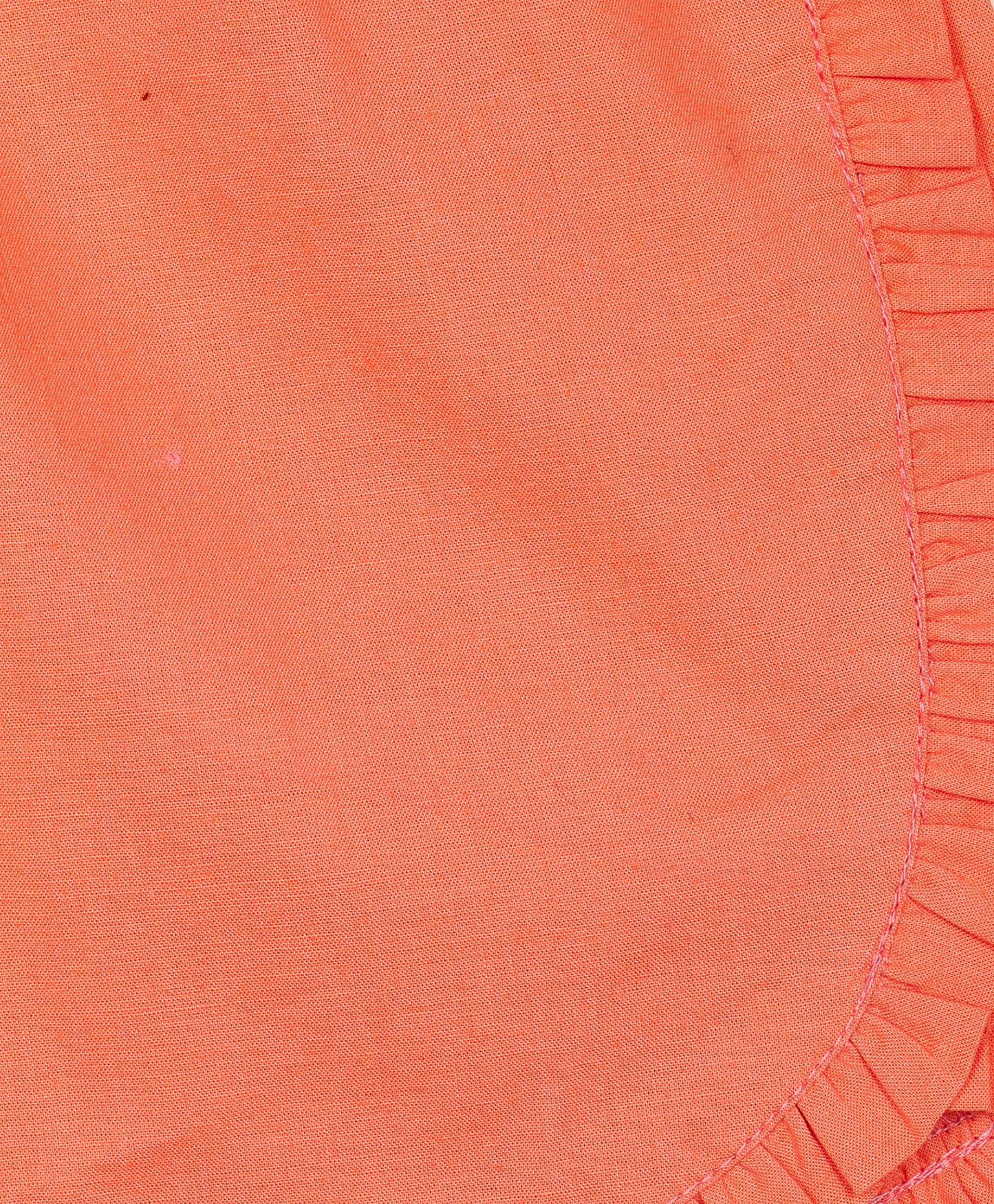 Orange shorts with frill detailing on the seams and bottom