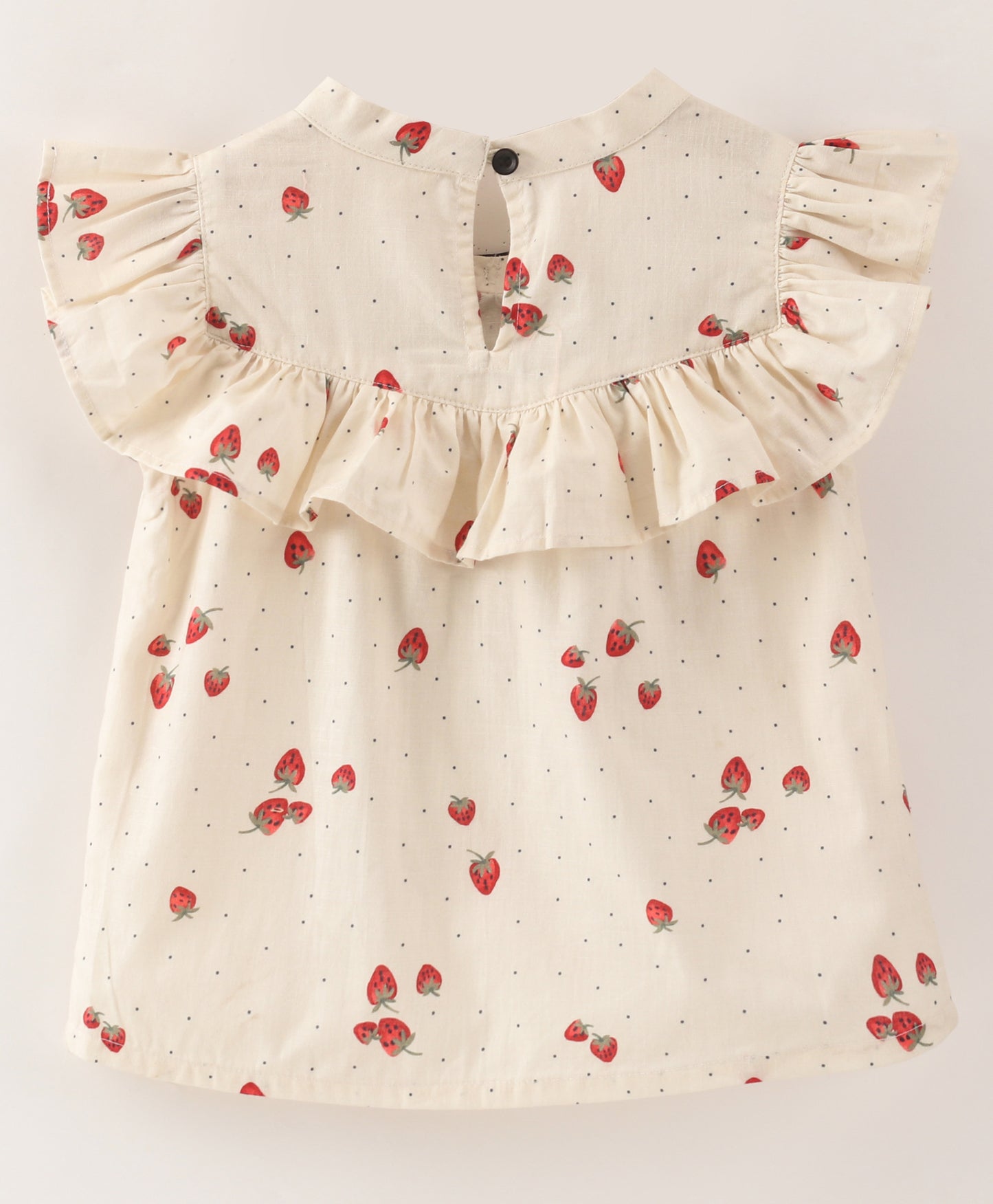 White top with strawberry and dot print with black bow tie at neck