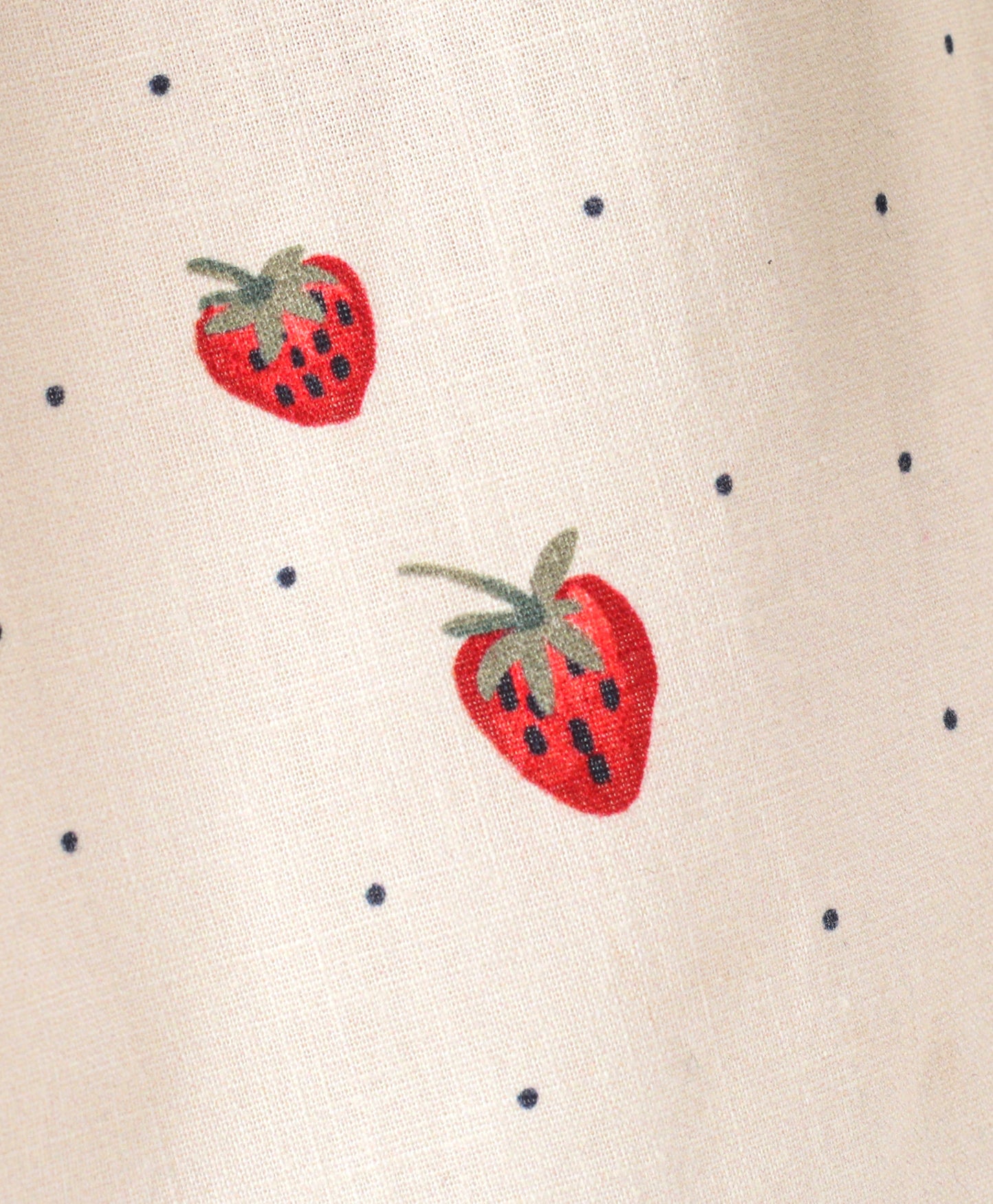 White top with strawberry and dot print with black bow tie at neck