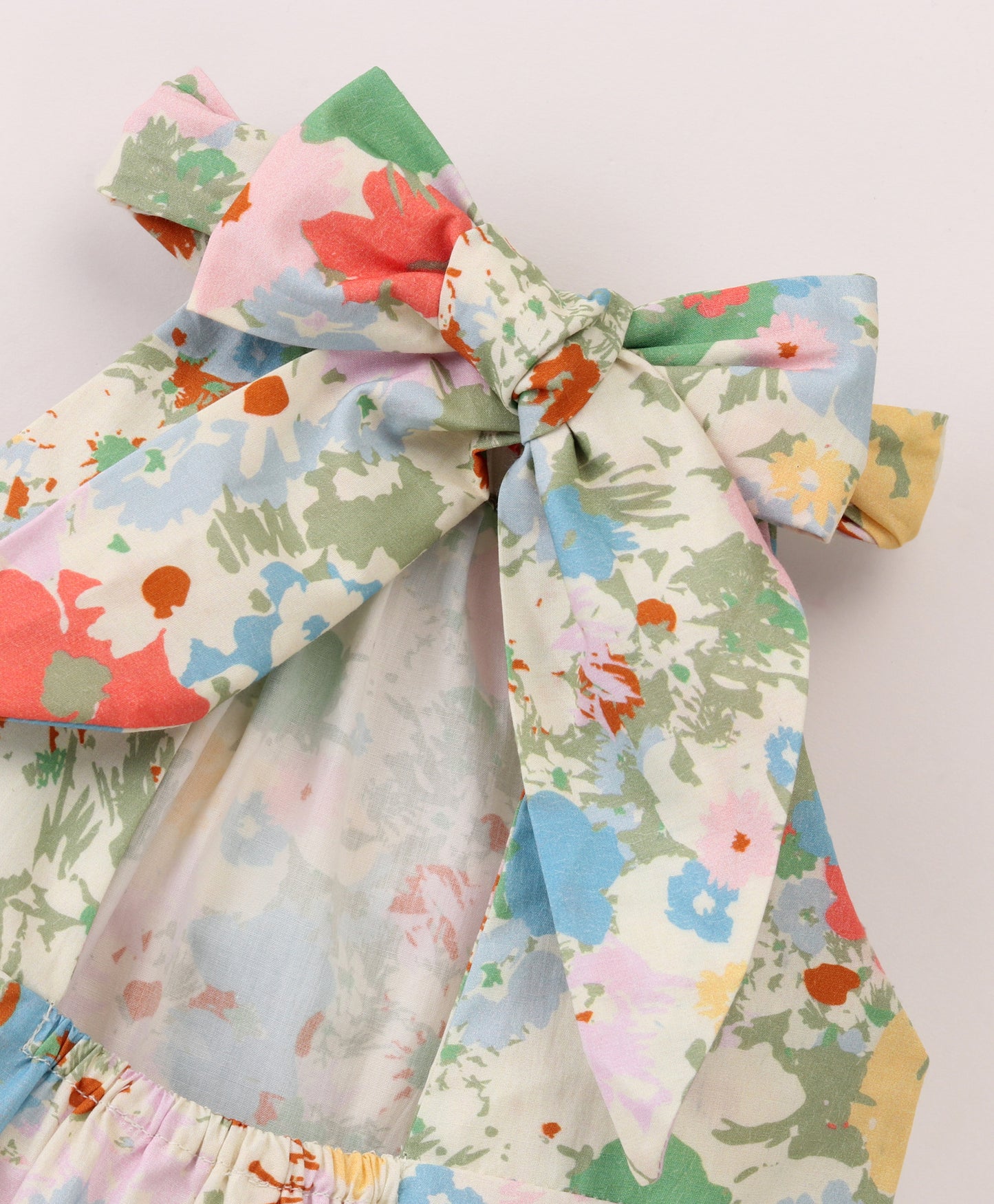 Pastel Floral print top with cut out at back and tie up at back neck