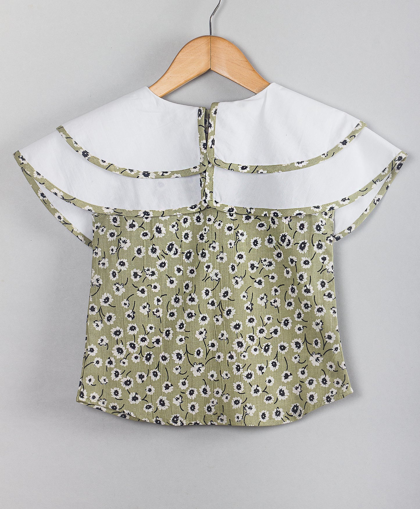 OLIVE GREEN FLORAL PRINT TOP WITH SOLID WHITE DOUBLE SHOULDER FLAPS