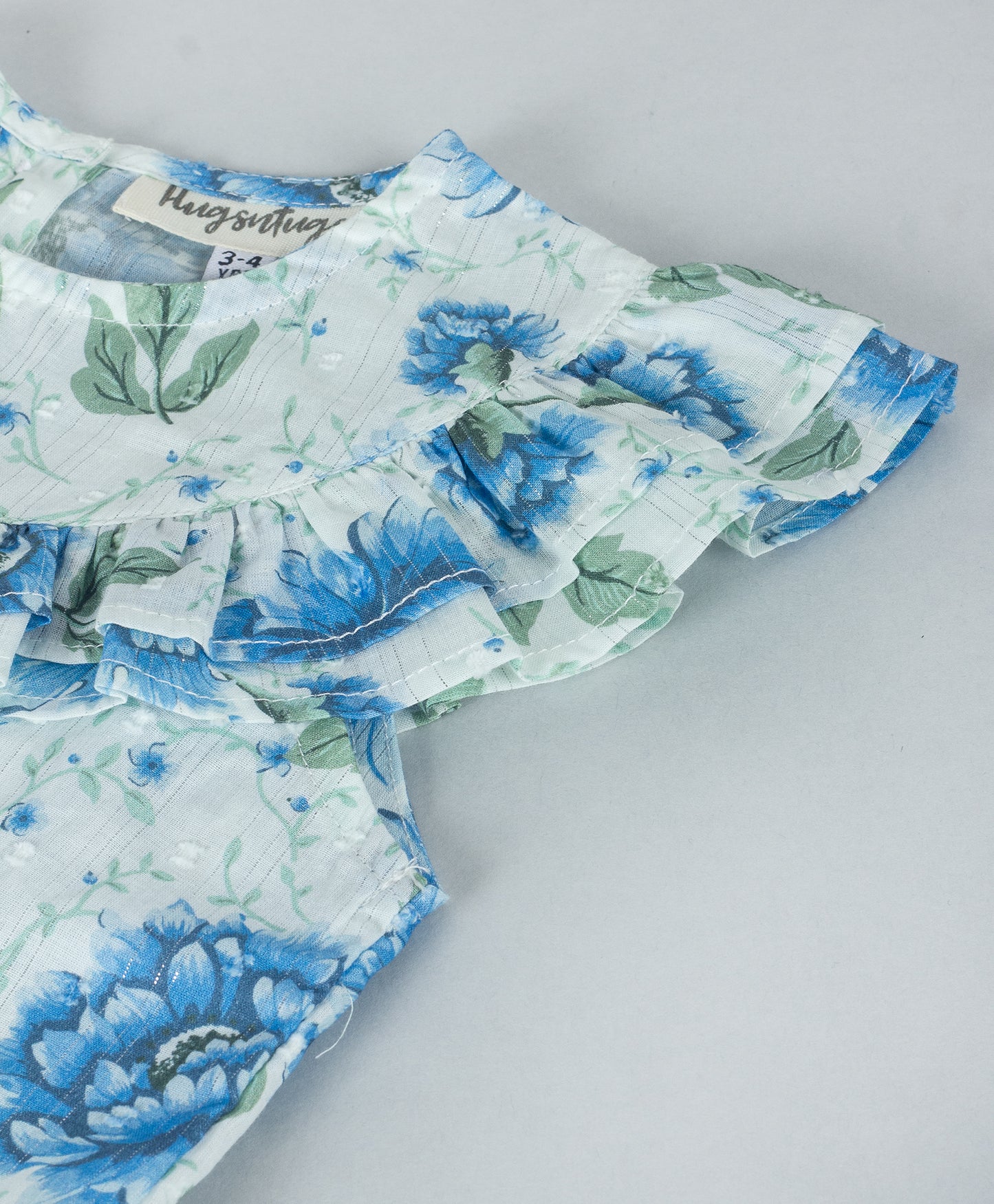 BLUE FLORAL PRINT TOP WITH FRILLS ALONG YOKE