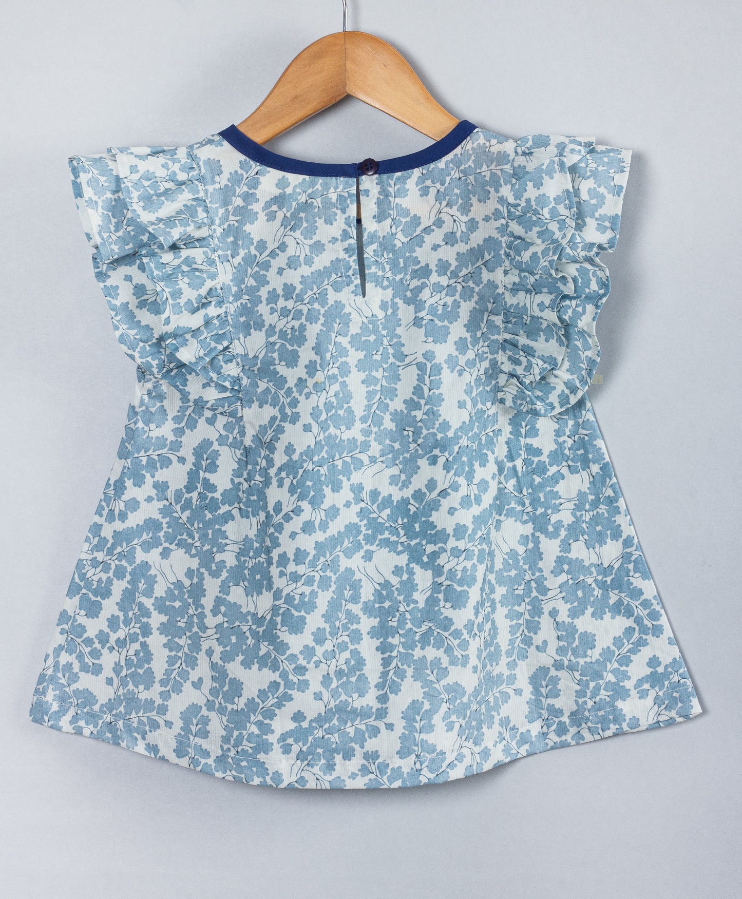 SOFT BLUE ALL OVER LEAF PRINT TOP WITH NAVY NECK BINDING AND TIE UP