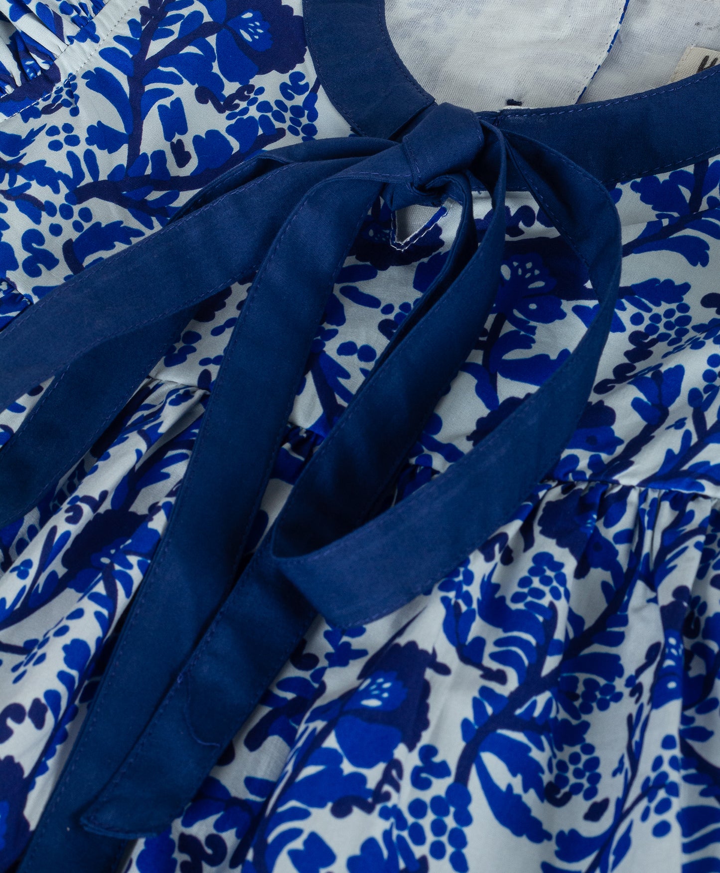 BLUE ALL OVER FLORAL PRINT WITH TIE UP AT NECK