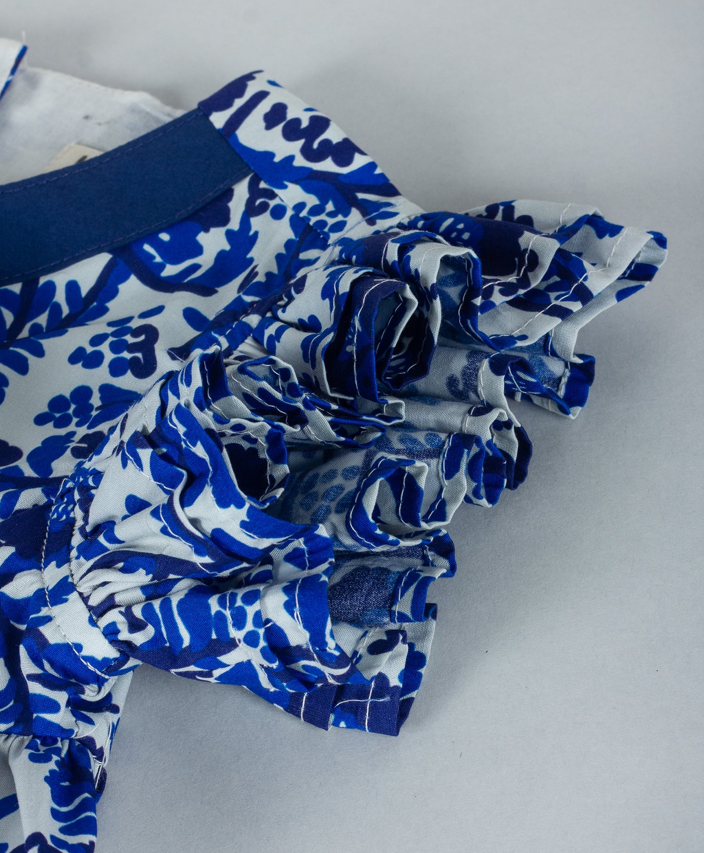 BLUE ALL OVER FLORAL PRINT WITH TIE UP AT NECK