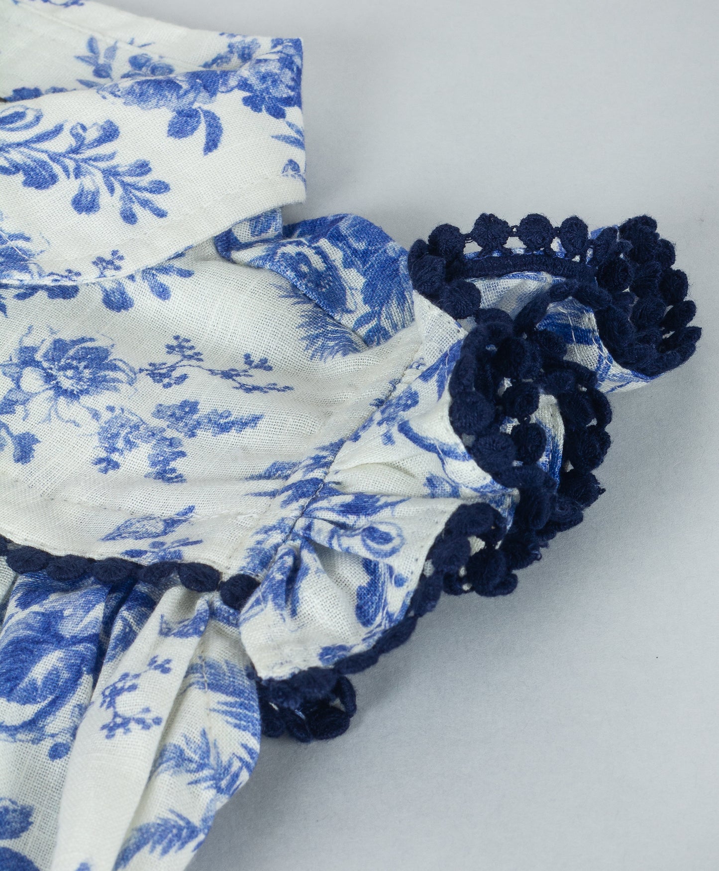 WHITE AND BLUE FLORAL TOP WITH NAVY LACE TRIMS