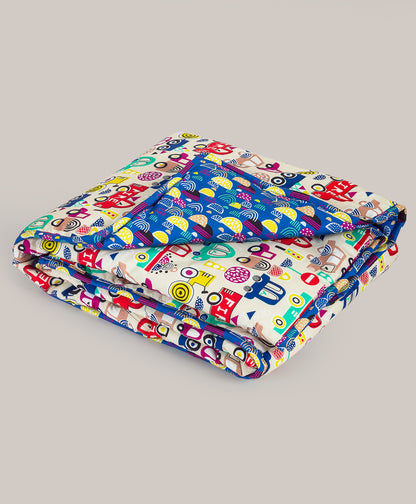 CAR PRINT AC QUILT WITH ABSTRACT PRINT LINING.
