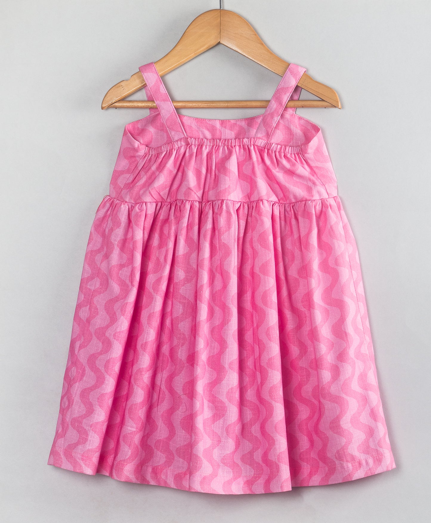 PINK SELF WAVE PRINT DRESS WITH RED BOW