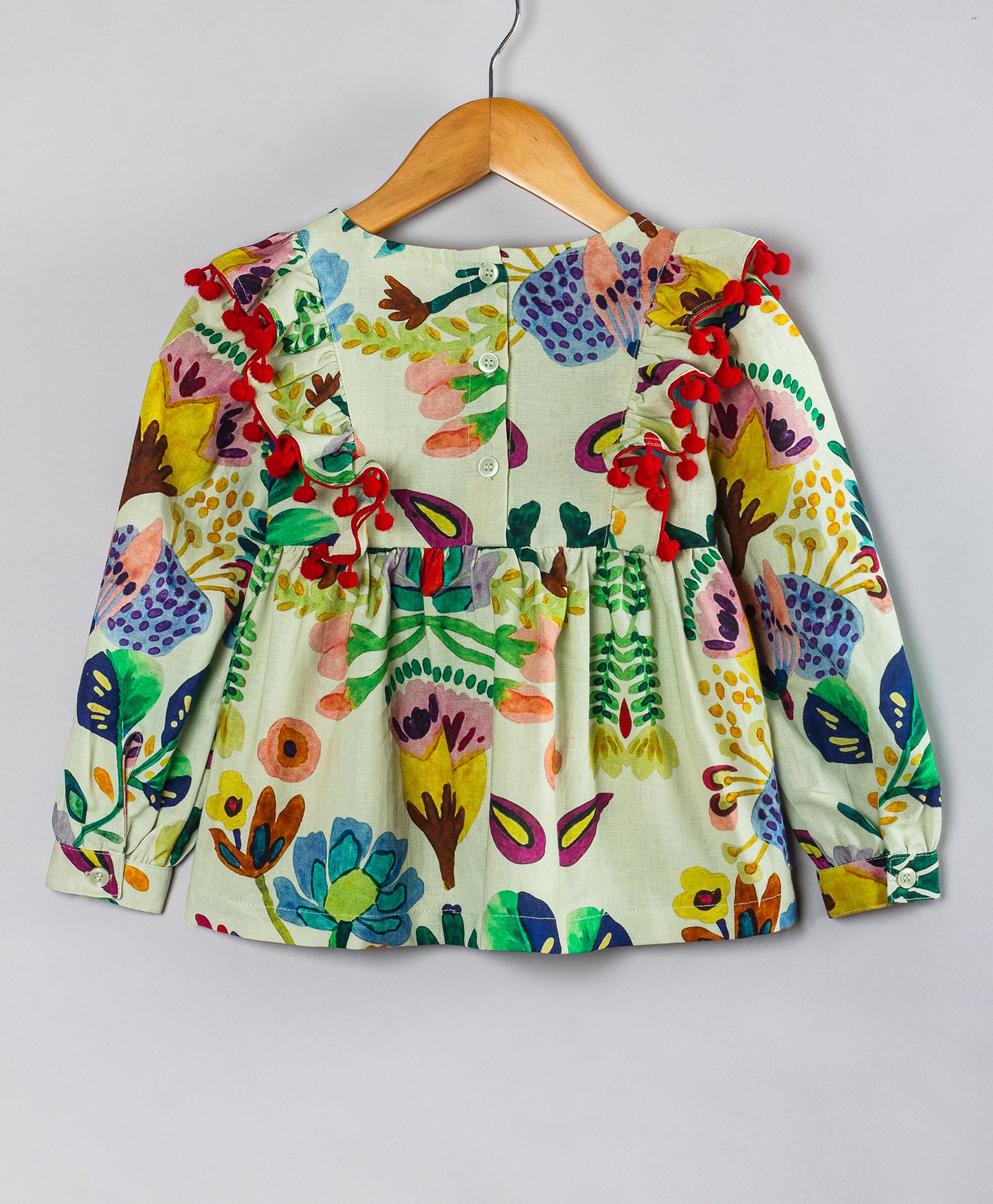 ECRU TOP WITH MULTI FLORAL PRINT AND RED POMPOM DETAILING