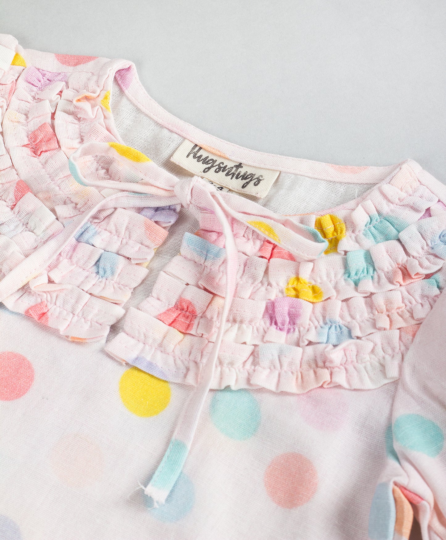 PINK DOT PRINT TOP WITH FRONT RUFFLES