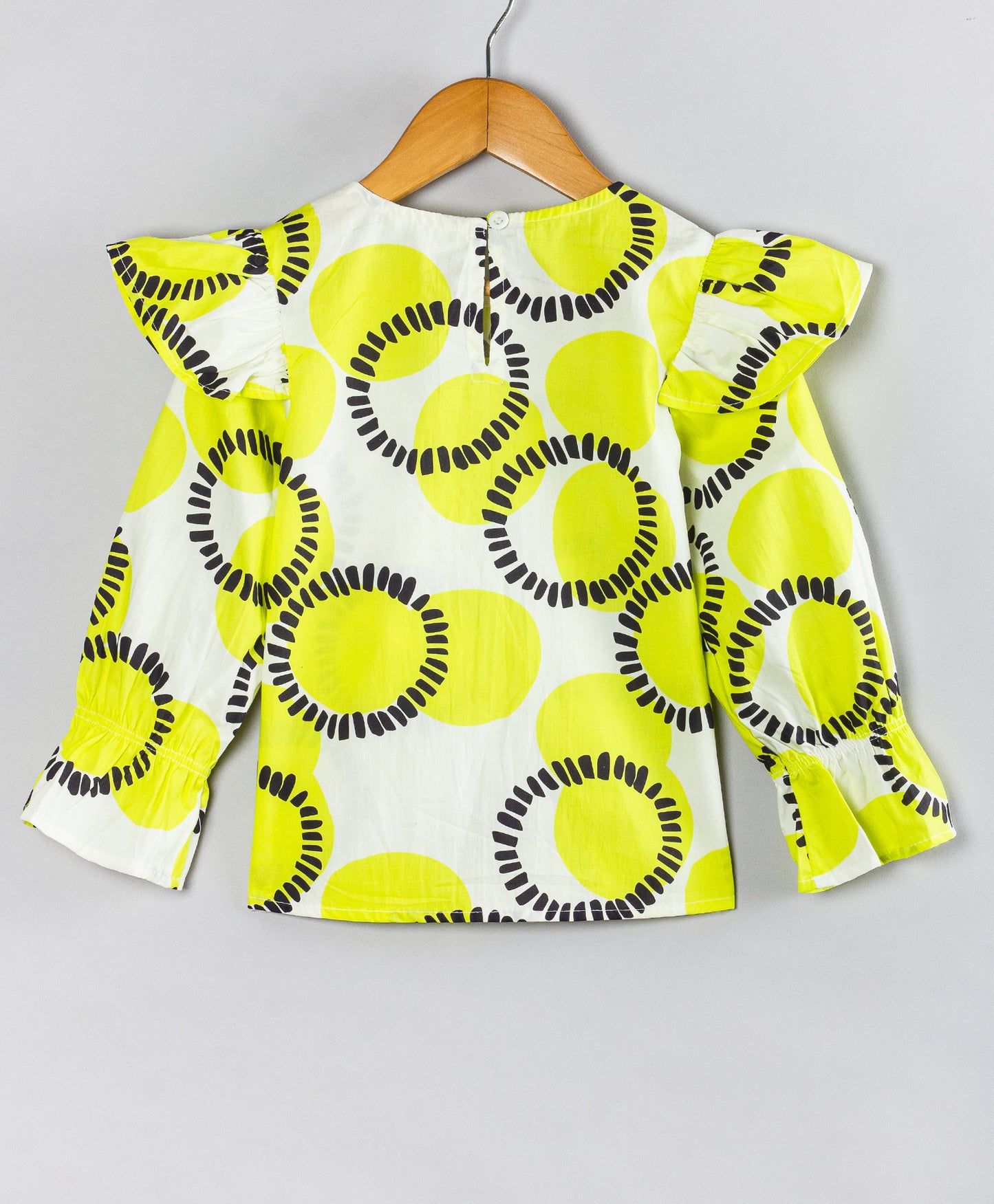 CIRCLE PRINT TOP WITH FRILL ACROSS FRONT