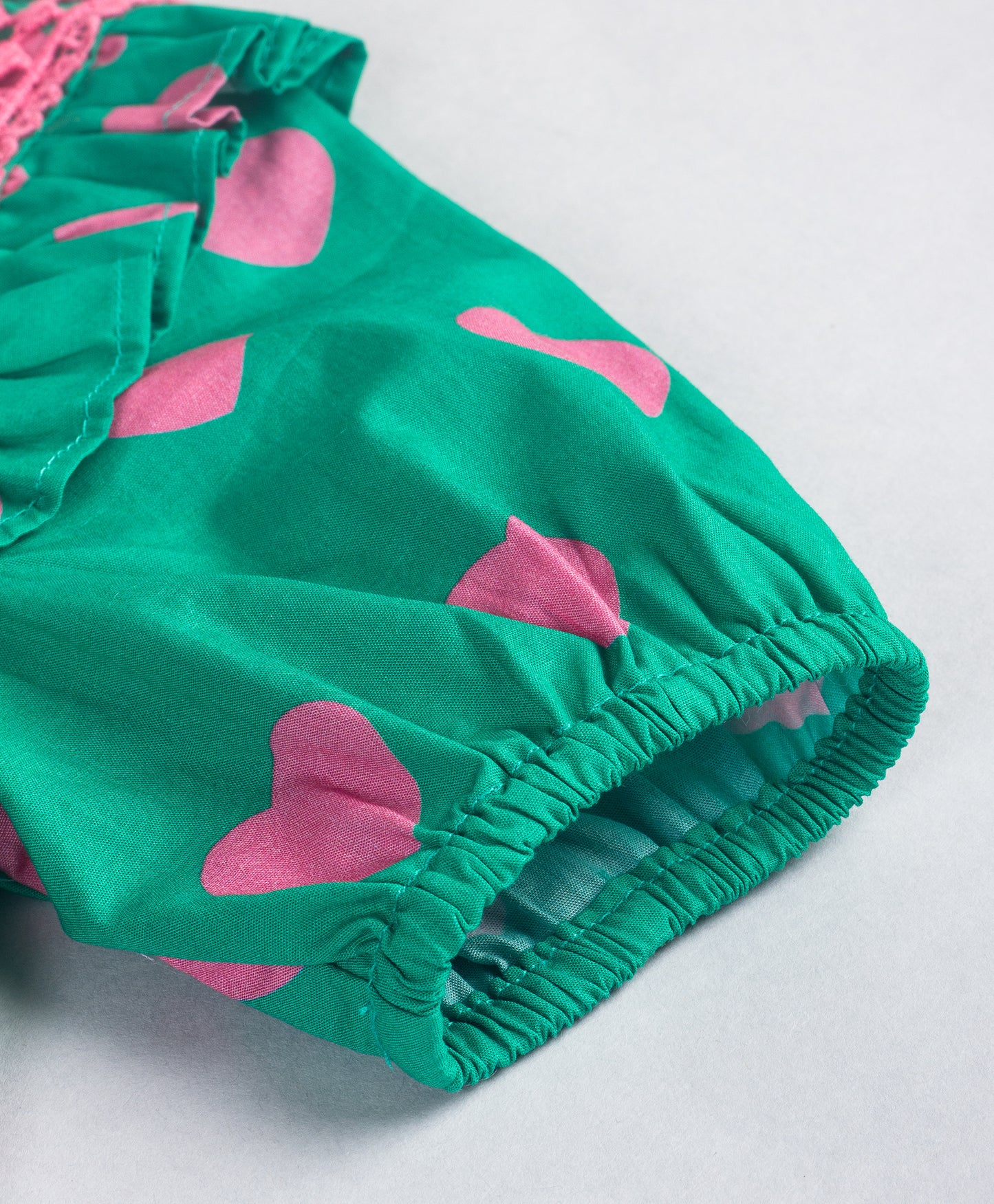 GREEN TOP WITH PINK HEART PRINT AND PINK LACE