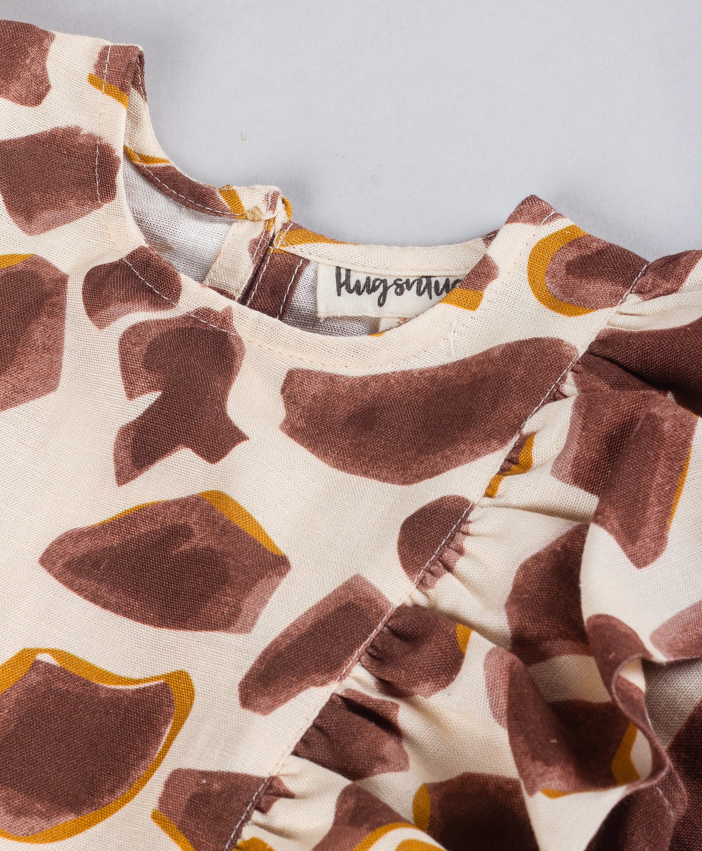 ABSTRACT PEBBLE PRINT TOP WITH SIDE FRILLS
