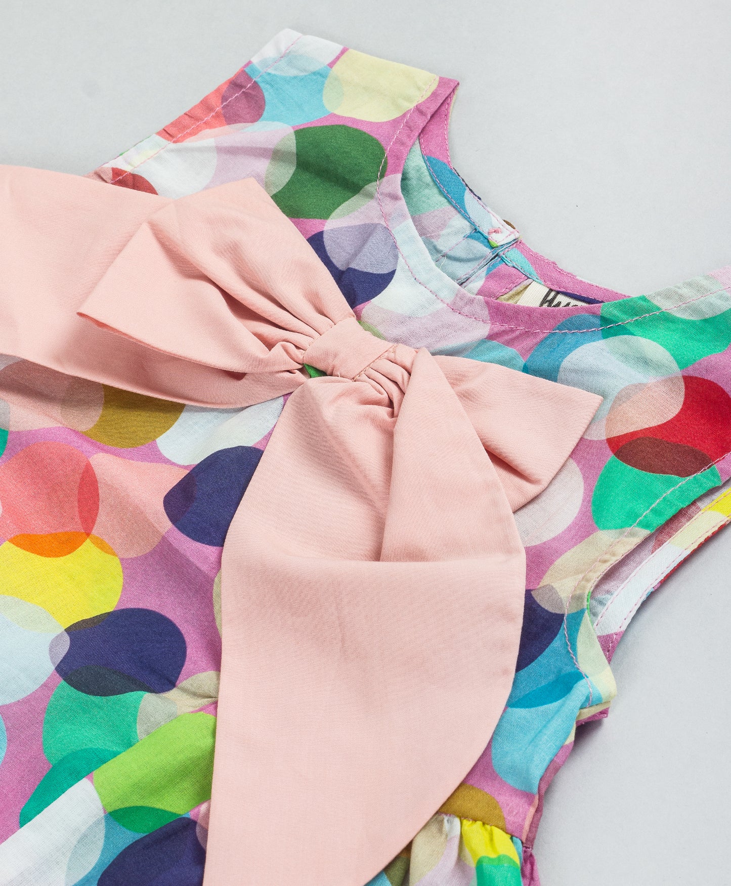 MULTI DOT PRINT TOP WITH CONTRAST BOW