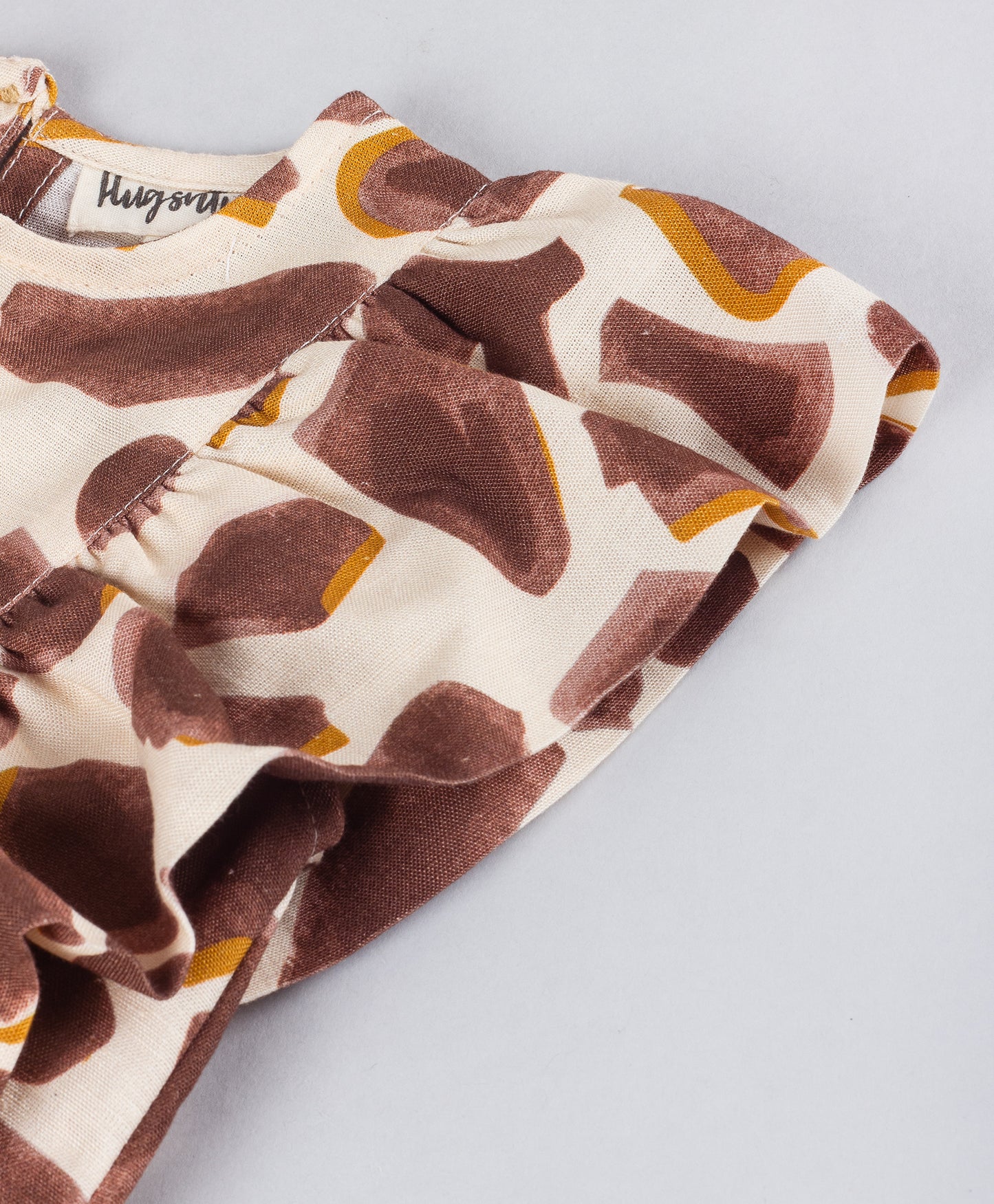 ABSTRACT PEBBLE PRINT TOP WITH SIDE FRILLS