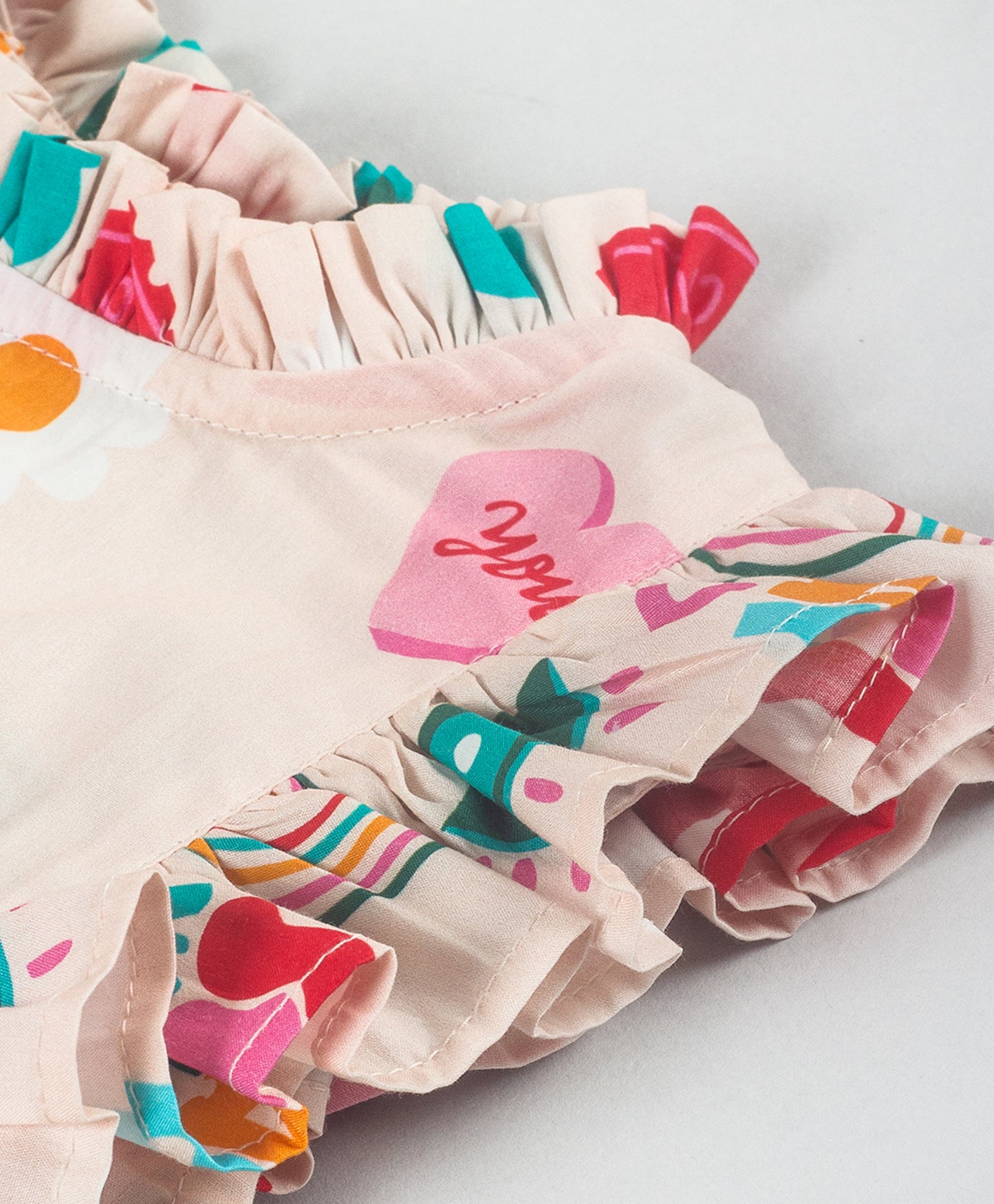 GRAFFITI PRINT TOP WITH FRILLS AT FRONT SIDES