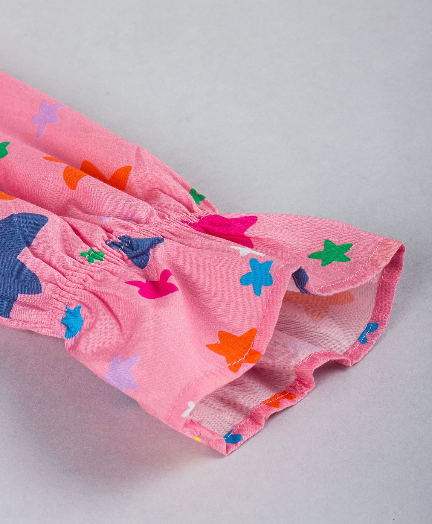 PINK STAR PRINT TOP WITH FRILL ACROSS FRONT