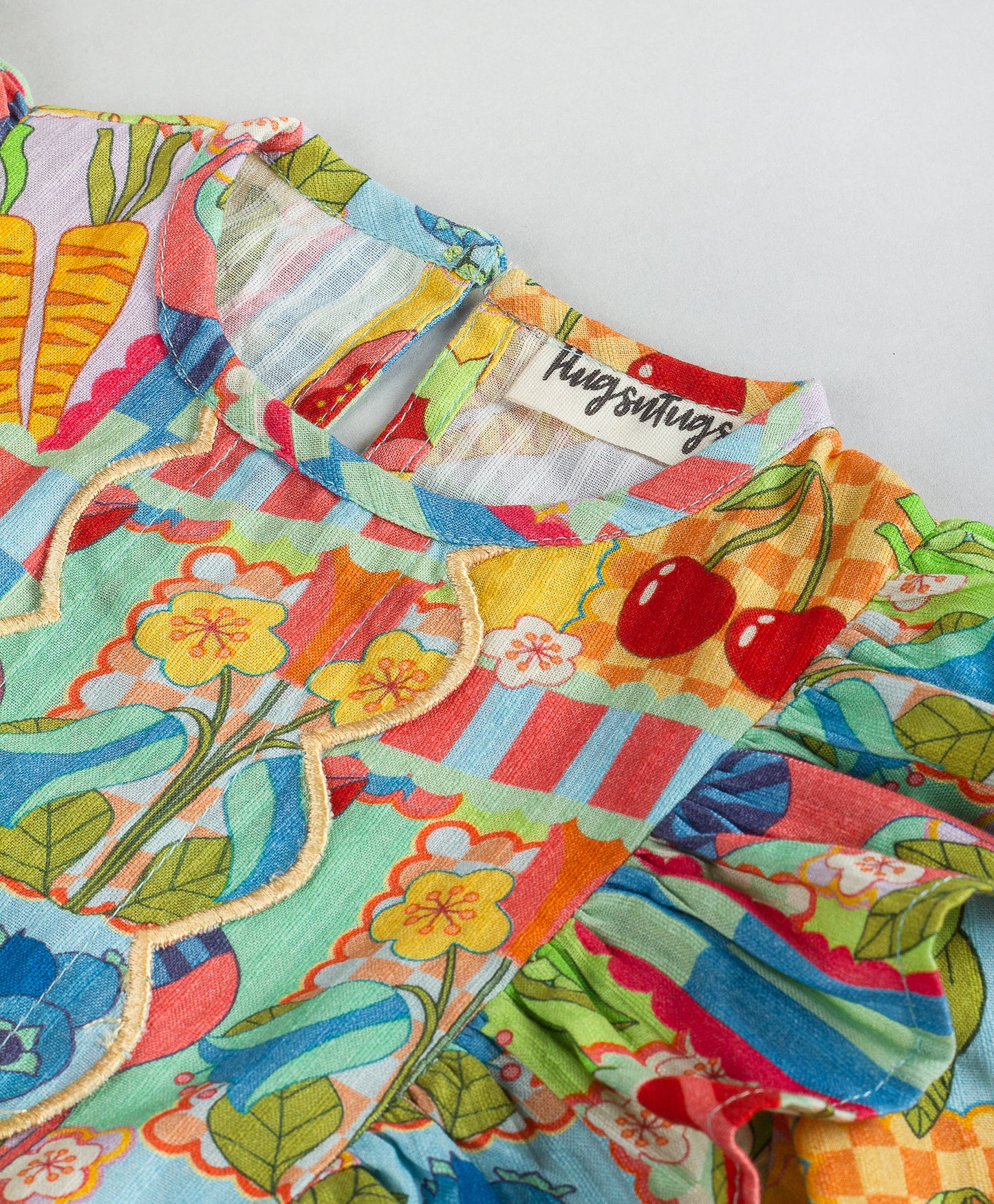 BUSY PRINT WITH CENTRE FRONT SCALLOP DETAILING
