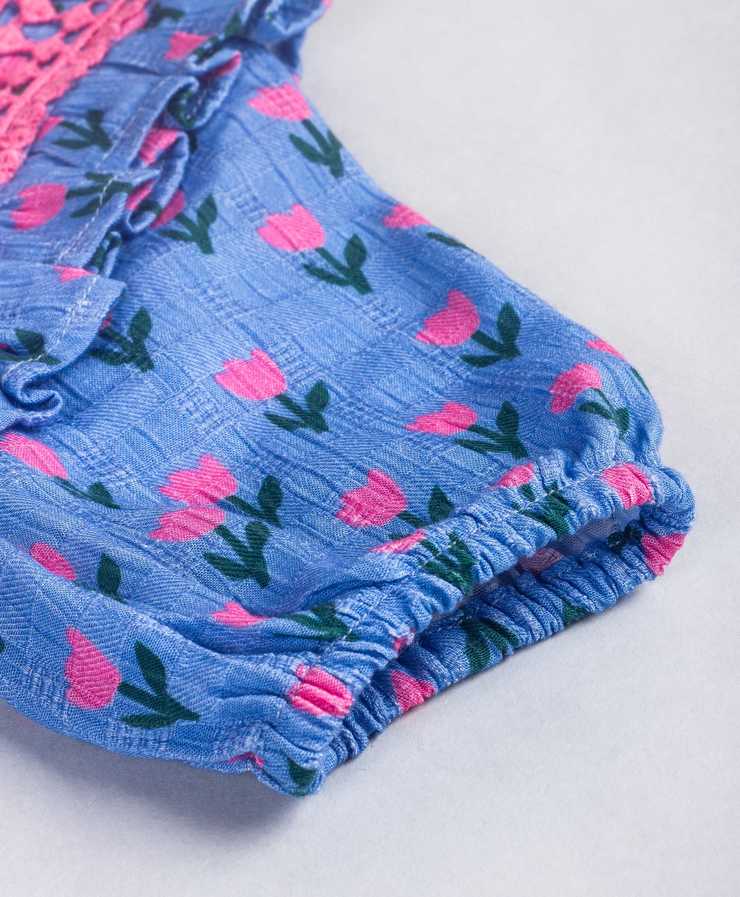 BLUE TOP WITH ALL OVER PINK TULIP PRINT AND PINK LACES