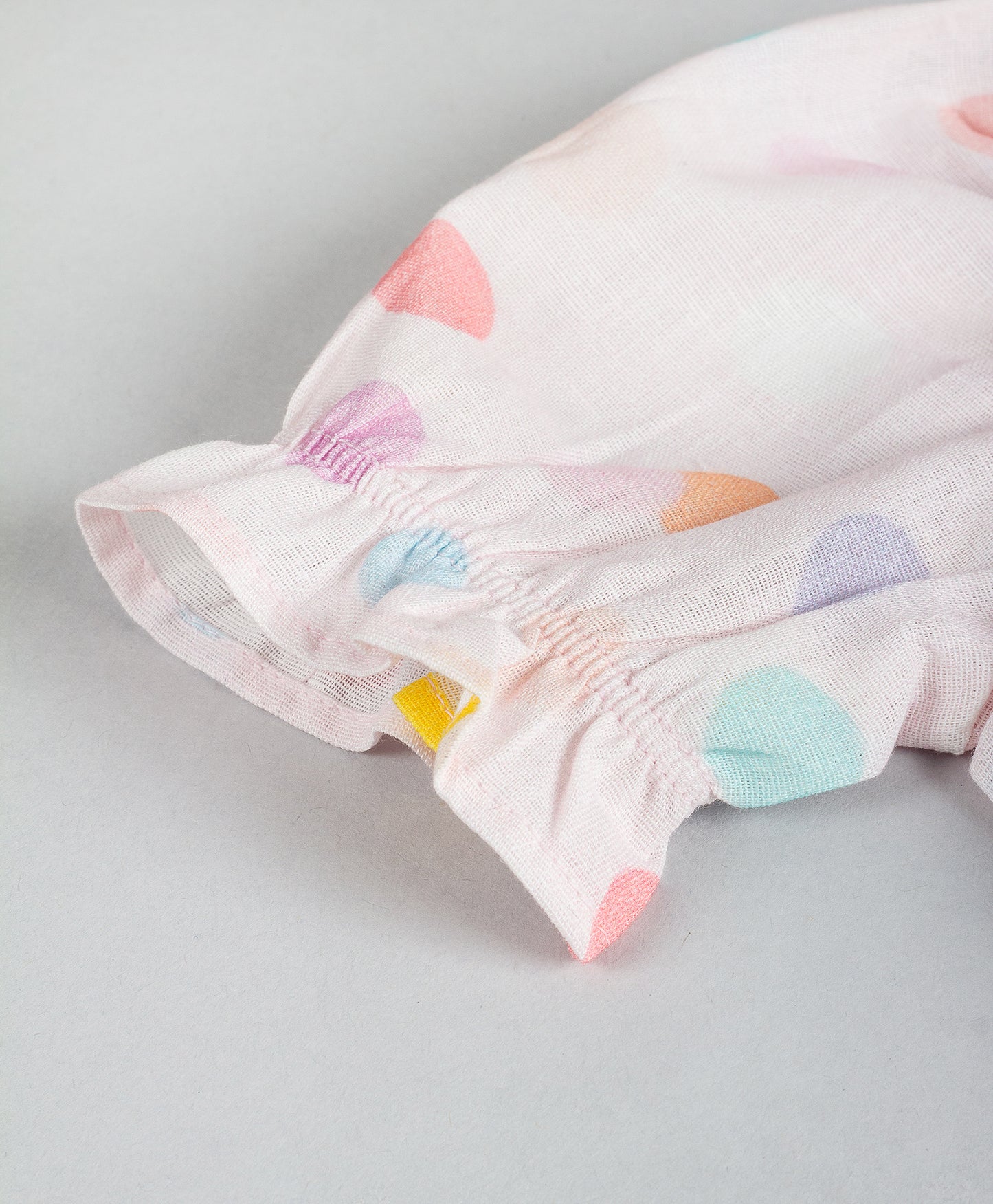 PINK DOT PRINT TOP WITH FRONT RUFFLES