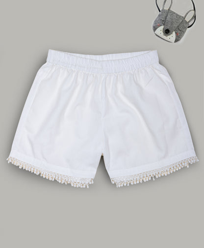 Solid White shorts with pom pom lace detailing at the bottom