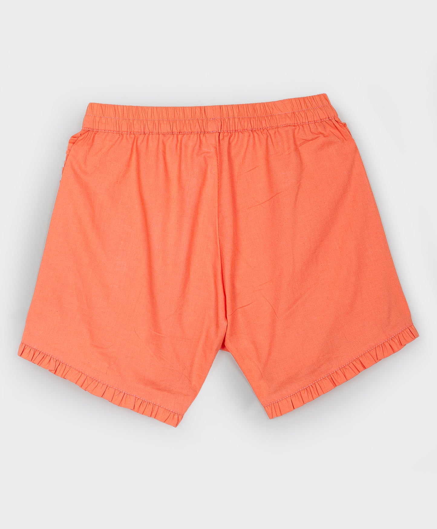 Orange shorts with frill detailing on the seams and bottom