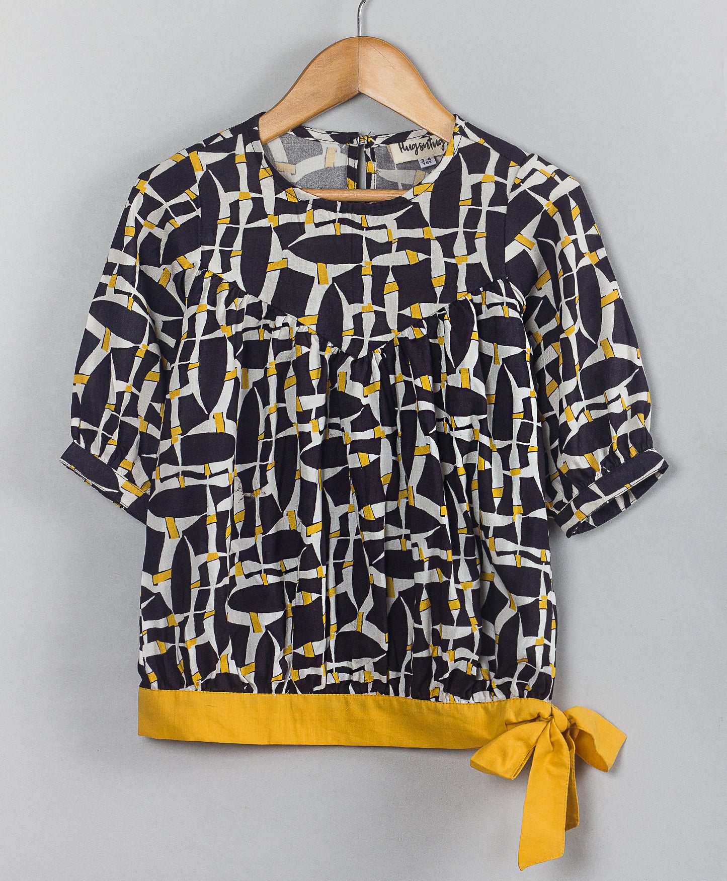 BLACK GEOMETRIC PRINT TOP WITH YELLOW TIE UP AT WAIST